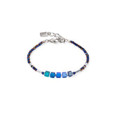 Bracelet with blue and silver beads on a white background