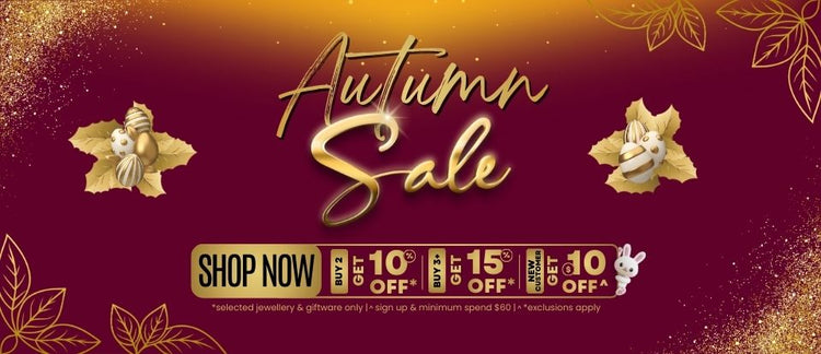 Autumn sale banner with decorative elements and easter eggs, leaves, glitter, cute bunny popping out on a maroon and gold background.