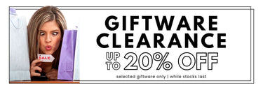 Sale banner for Giftware Clearance with a woman between gift bags and holding a small sale tag.