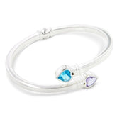 Silver bracelet with heart-shaped blue and purple gemstones on a white background