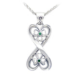 Silver connected hearts pendant with shamrock and green gemstones on a white background