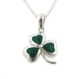 Green shamrock pendant with silver setting on a white background