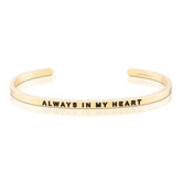 Gold bracelet with 'Always in My Heart' engraving on a white background