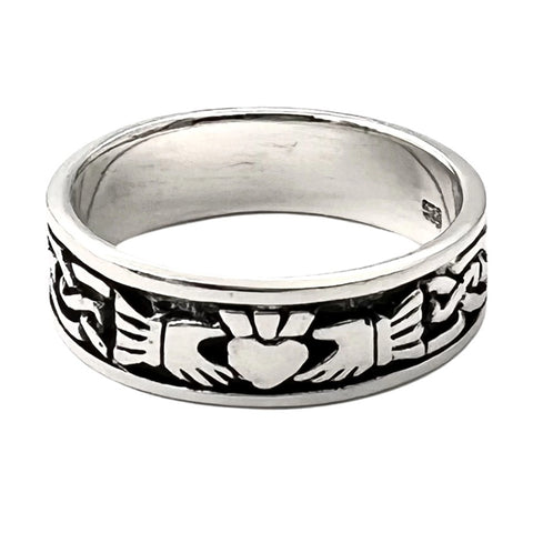 Silver claddagh band ring with intricate design on a white background