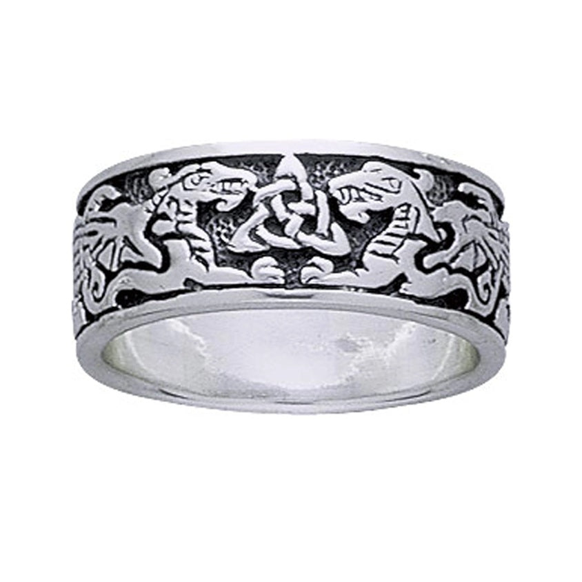 Silver ring with intricate design of dragons and trinity triquetra knot on a white background