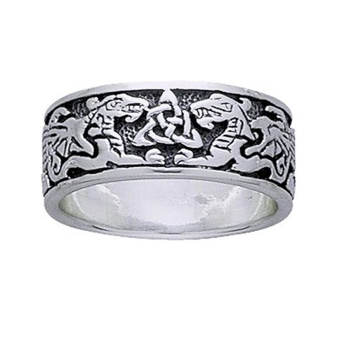 Silver ring with intricate design of dragons and trinity triquetra knot on a white background