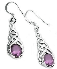 Silver celtic knot earrings with purple amethyst gemstones laying flat on a white background