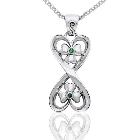 Silver connected hearts pendant with shamrock and green gemstones on a white background