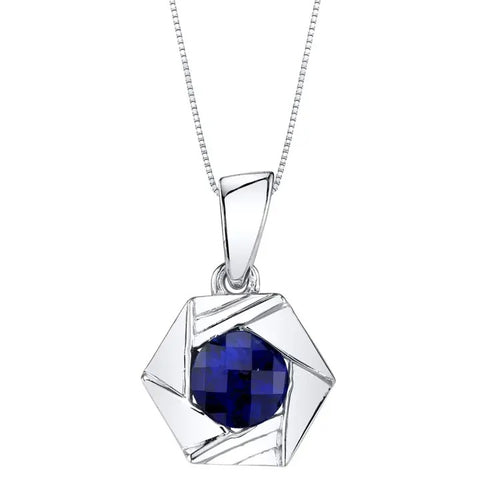 Silver pendant with a blue sapphire gemstone on a white background