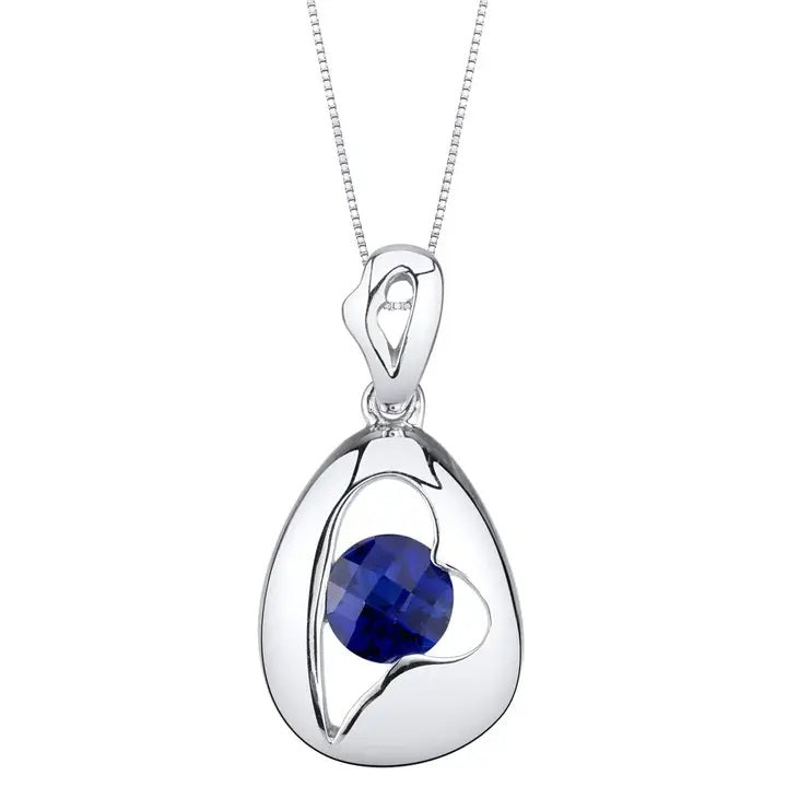 Silver pendant with a blue sapphire gemstone on a white background