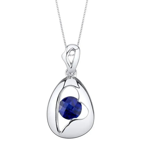 Silver pendant with a blue sapphire gemstone on a white background