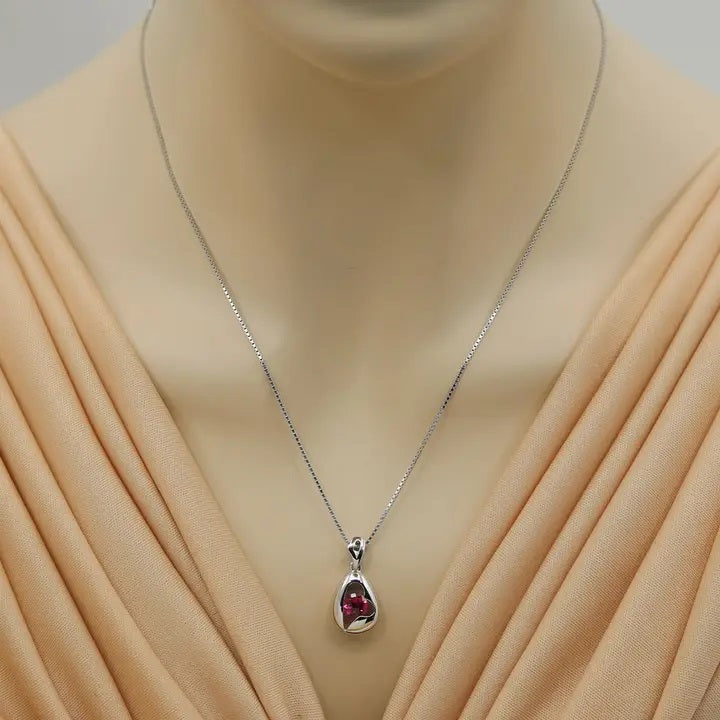 Necklace with a pendant on a mannequin wearing a beige dress