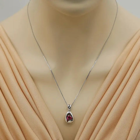 Necklace with a pendant on a mannequin wearing a beige dress
