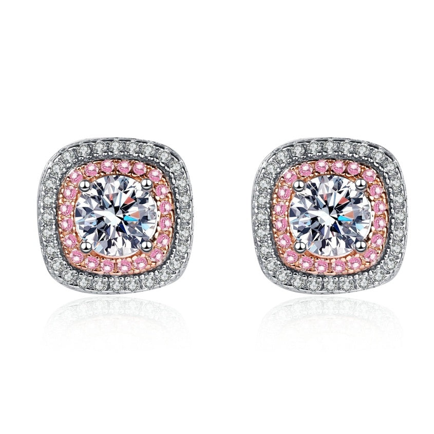 Pair of earrings with pink and clear moissanite gemstones on a white background