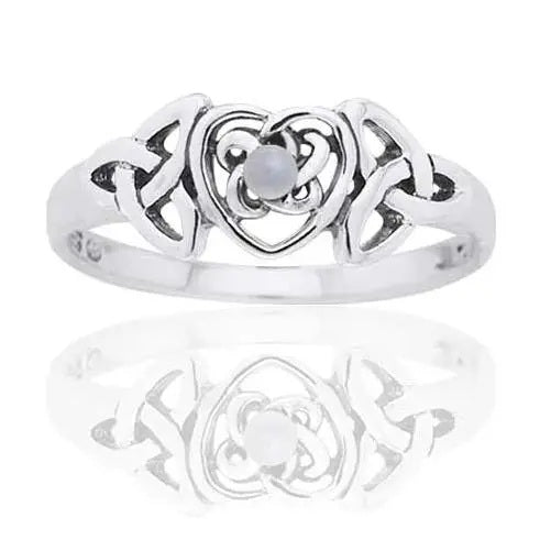 Silver ring with heart and Celtic triquetra trinity knot design with mother of pearl gemstone in centre on a white background