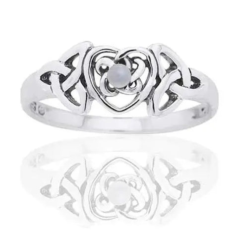 Silver ring with heart and Celtic triquetra trinity knot design with mother of pearl gemstone in centre on a white background