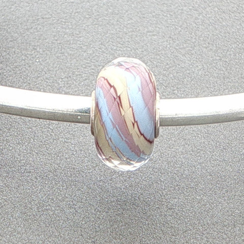 Marbled glass bead on a silver rod against a grey background